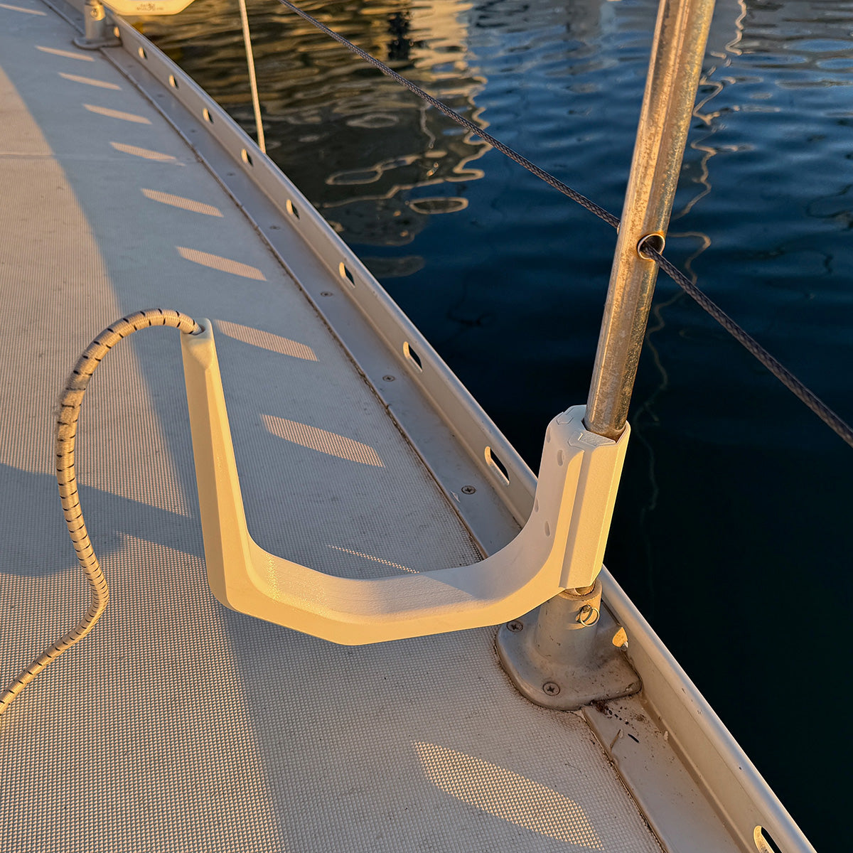 SUP board holder on inside of boat rail – keeps walkway clear when moored at marina