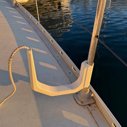 SUP board holder on inside of boat rail – keeps walkway clear when moored at marina